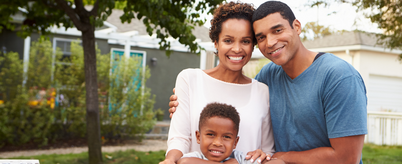 photo of black family in front of house