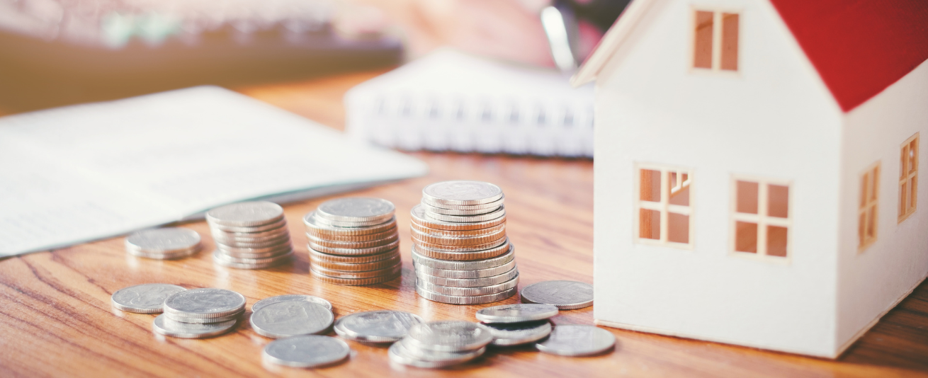 image of stacks of coins and model house