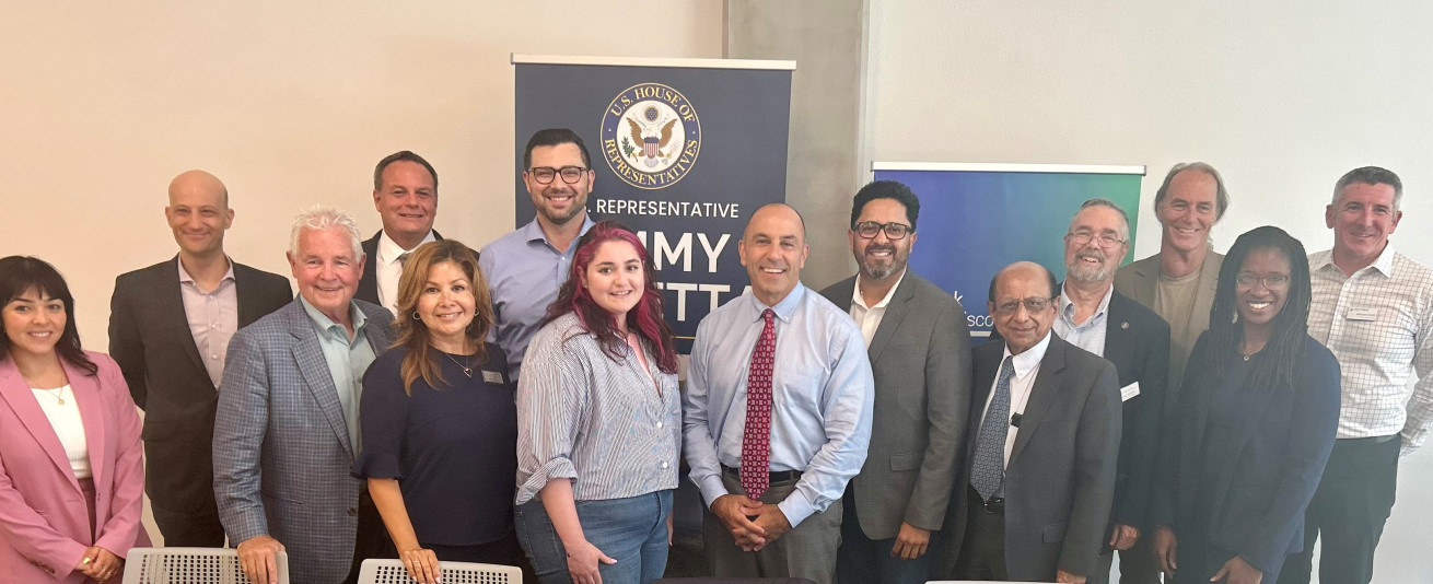 photo of U.S. Rep. Panetta (center) with community stakeholders attending an affordable housing roundtable discussion