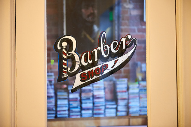 Commercial tenants on the ground floor include a barber shop, a restaurant, and a church.