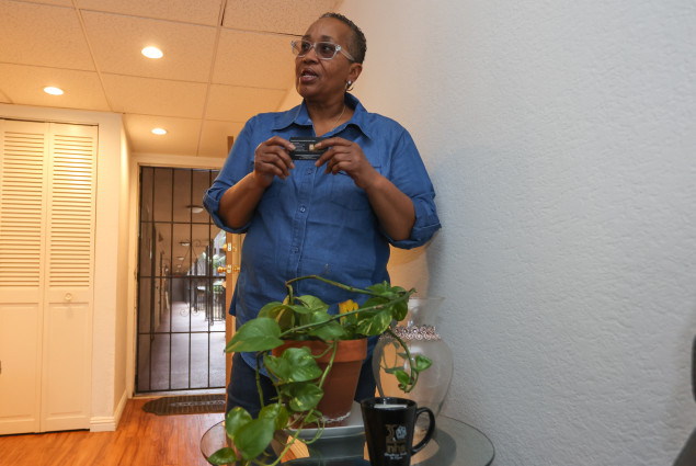 Photo of Doris Ealy holding NHS business card.