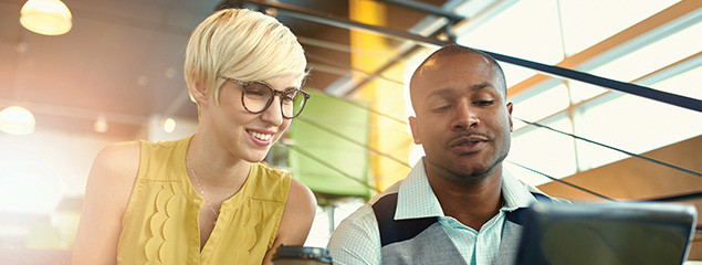 Two people looking at a tablet